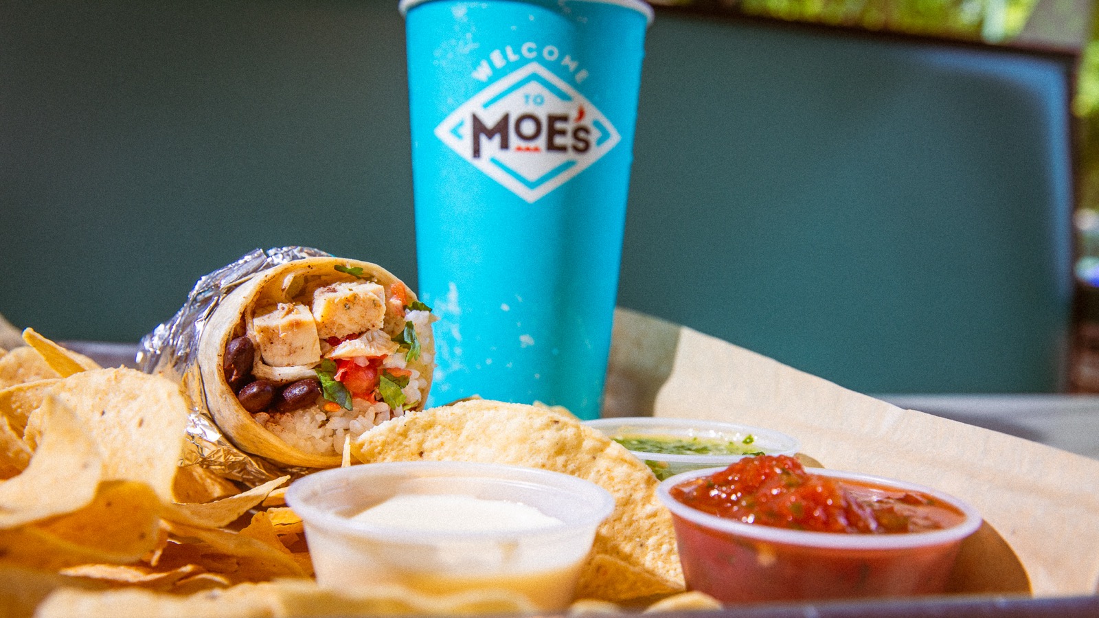 Moe's value meal with burrito, queso, chips, salsa, and drink
